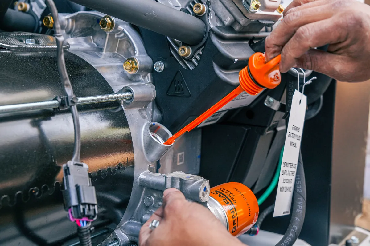Close-up of the oil fill and dipstick on a standby generator engine